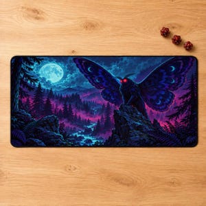 May include: A rectangular desk mat featuring a dark, nocturnal forest landscape with a large, winged moth creature perched on a rocky cliff. The scene includes a bright full moon, glowing blue river, and vibrant purple and blue tones throughout.