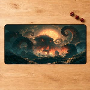 May include: A rectangular desk mat featuring a dark, dramatic illustration of a giant sea monster with glowing red eyes emerging from turbulent ocean waves under a fiery orange sun, surrounded by swirling tentacles and a small sailing ship.