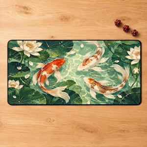 May include: A rectangular desk mat featuring a vibrant illustration of three koi fish swimming among green lily pads and white lotus flowers. The design includes shades of orange, white, and deep green. Three small red dice are placed nearby.