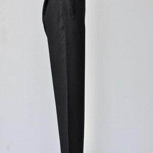 May include: Black tailored pants with a single front pocket.
