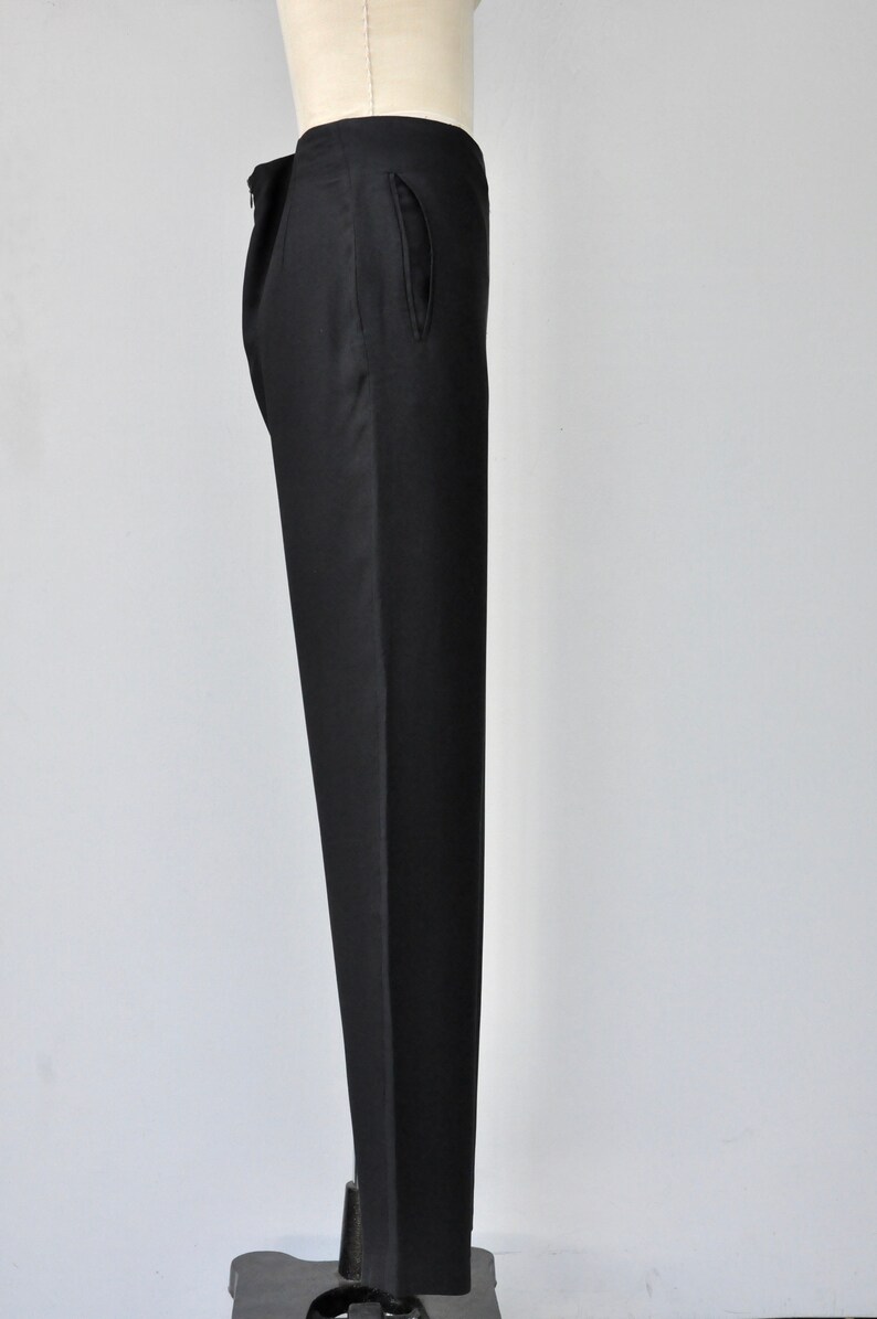 May include: Black tailored pants with a single front pocket.