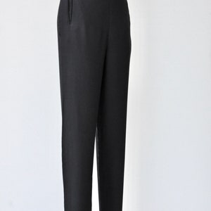 May include: Black tailored pants with a high waist and a straight leg.