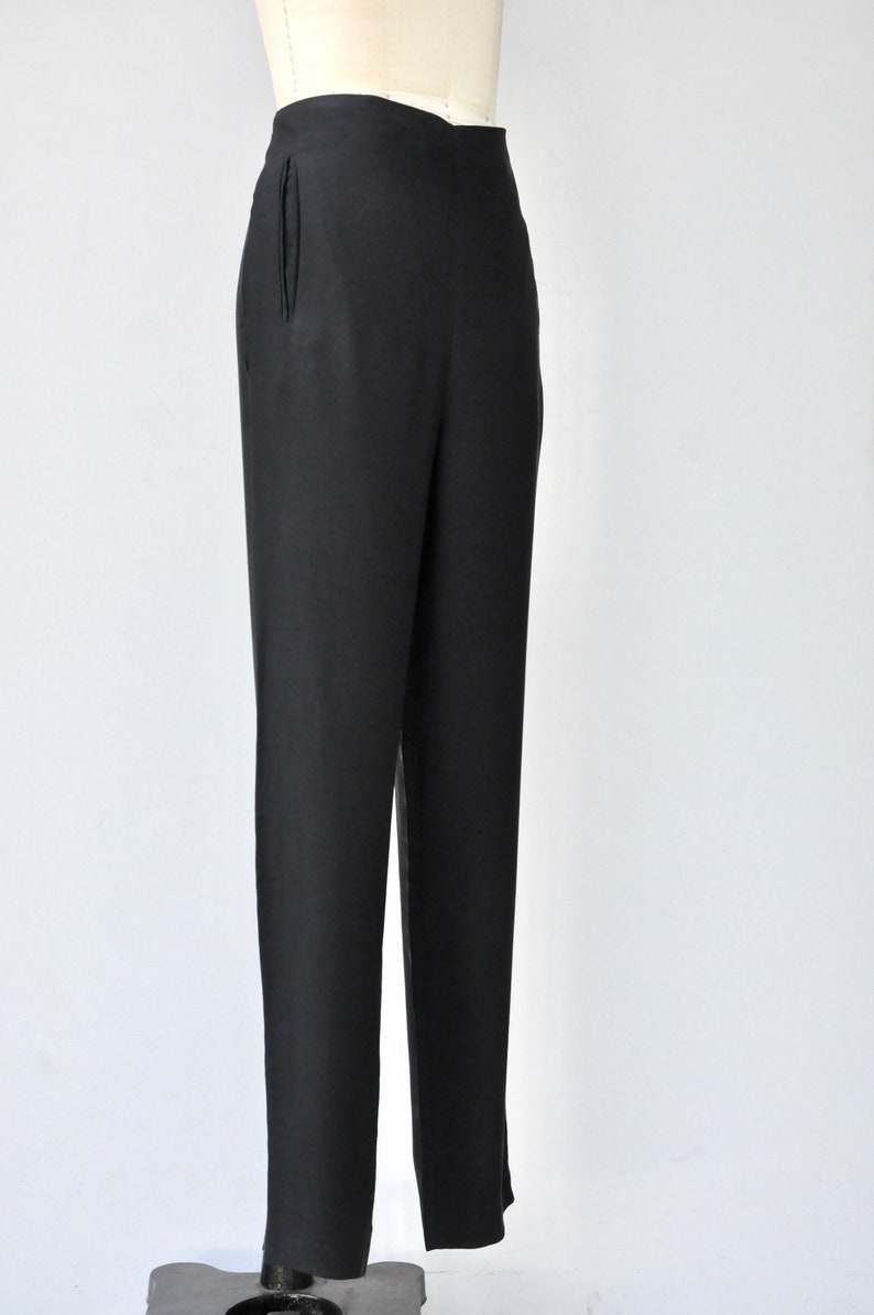 May include: Black tailored pants with a high waist and a straight leg.