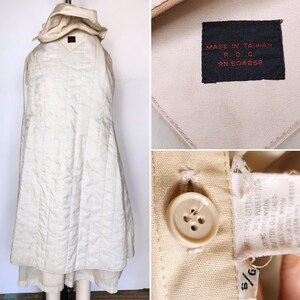 May include: A white quilted hooded jacket with a label that reads "MADE IN TAIWAN R.C.C. RN 504858". The jacket has a size tag that reads "9/9".