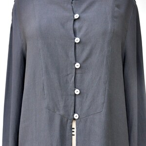 May include: A long-sleeved black button-up shirt with a center front opening. The shirt has a simple, classic design and is made of a lightweight fabric.