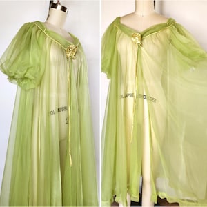 May include: A vintage lime green sheer robe with short sleeves and a gold-colored trim. The robe features a decorative gold flower at the neckline and a matching tie. The fabric is lightweight and flowing, creating a delicate and elegant look.