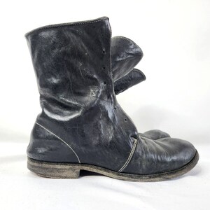 May include: Black leather ankle boots with a lace-up front and a distressed look.