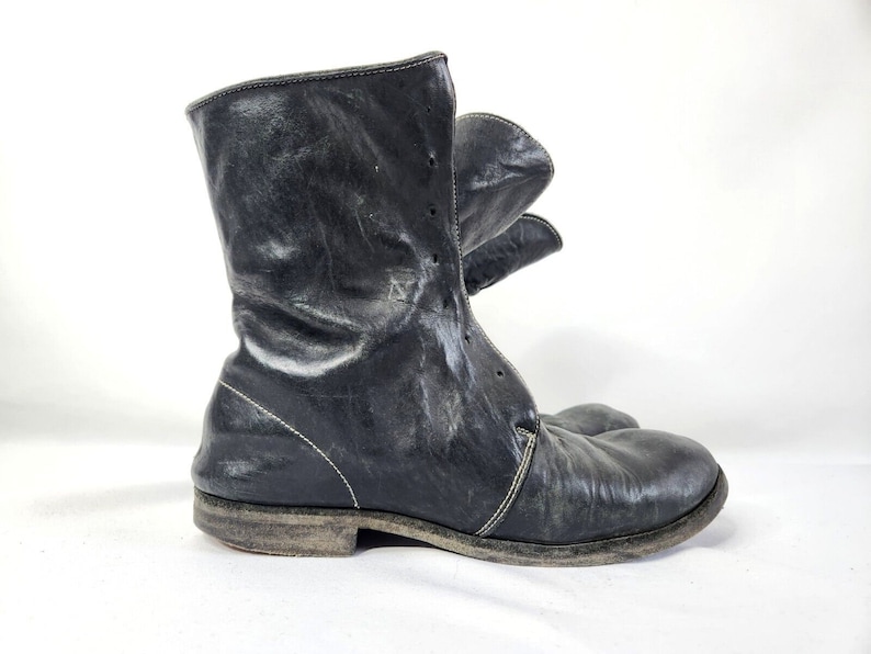 May include: Black leather ankle boots with a lace-up front and a distressed look.