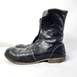 May include: Black leather ankle boots with a lace-up front and a distressed finish.
