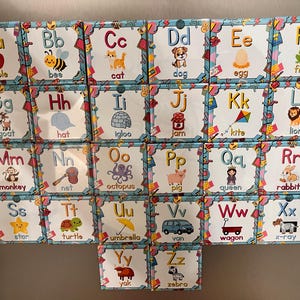 May include: A set of twenty-six square educational cards arranged in a grid, each featuring a letter of the alphabet from A to Z, accompanied by a corresponding colorful illustration and word, such as apple, bee, cat, dog, egg, frog, and zebra.