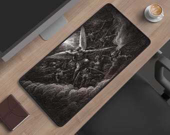 May include: A rectangular desk mat featuring a detailed black and white illustration of a winged figure in combat with multiple demonic entities amidst swirling clouds and a bright light source, set against a dark, high-contrast background.