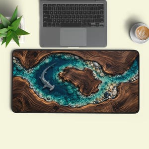 May include: A rectangular desk mat featuring a high-resolution print of a hammerhead shark swimming in a clear blue river-like channel surrounded by dark brown wood grain textures and smooth river stones along the edges of the water.