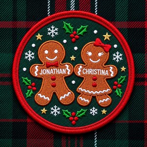 May include: A circular embroidered patch featuring two brown gingerbread figures on a dark green background. The left figure wears a red bow tie and is labeled JONATHAN, while the right figure wears a red hair bow and is labeled CHRISTINA.