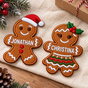 May include: Two embroidered gingerbread person ornaments. The left one wears a red and white Santa hat and has the name JONATHAN stitched in white. The right one features green holly leaves with red berries and the name CHRISTINA stitched in white.
