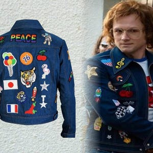 May include: A dark blue denim jacket featuring numerous colourful embroidered patches, including the word PEACE, a tiger head, a Japanese flag, a French flag, cherries, balloons, and a rocket, shown from both the back and front views.