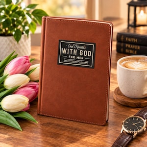 May include: A brown leather-bound daily devotional journal with a black rectangular label on the front cover. The label features the white text "One Minute WITH GOD FOR MEN DAILY DEVOTIONAL JOURNAL" in a clean, sans-serif and script font combination.