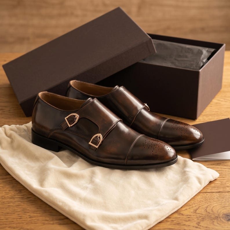 Double monk strap shoes packaged in branded dust bag, ready for gift-giving or shipping