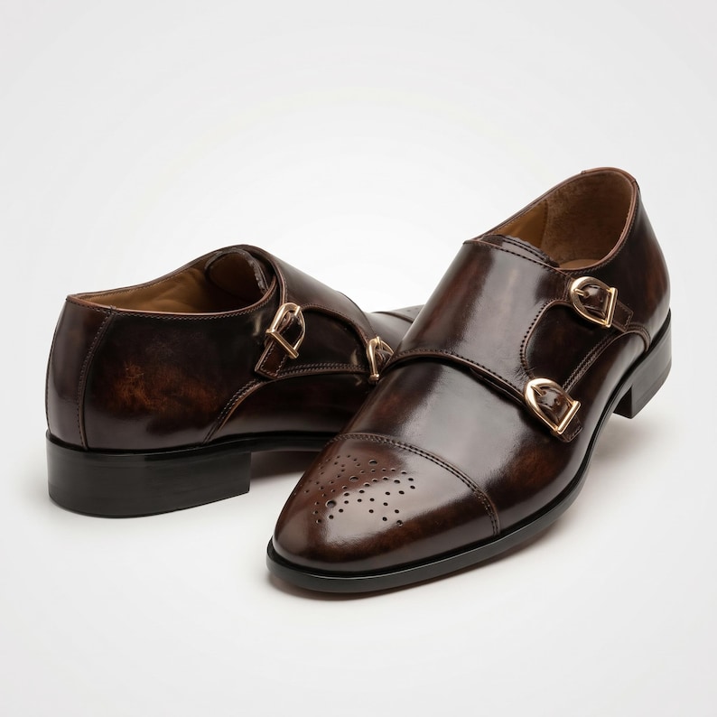 Side profile of double monk strap shoe showing gold-tone buckle closures
Pair of handmade dark brown calfskin double monk strap shoes displayed together