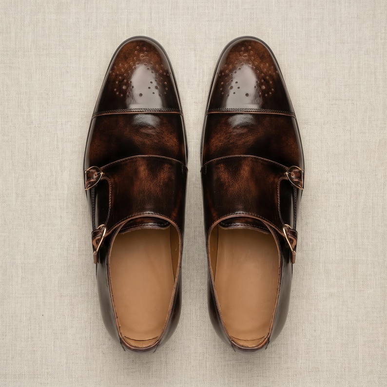 Flat lay top-down view of hand painted dark brown double monk strap shoe pair