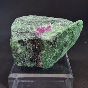 Ruby in Zoisite from Tanzania, Africa. This shining specimen has a beautiful green with an intense two sided ruby specimen in its center.
