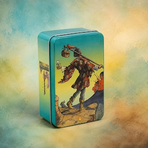 May include: A rectangular teal metal tin featuring a colourful illustration of a figure walking on a cliff edge with a staff and a small bag. The figure wears a patterned tunic and boots, holding a white flower, with a small dog nearby.