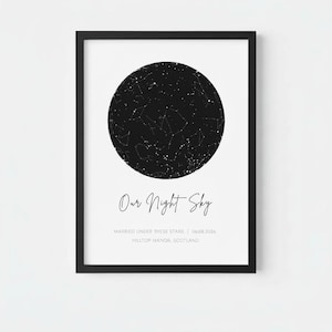 May include: A framed vertical print featuring a circular black star map on a white background. The text reads Our Night Sky, MARRIED UNDER THESE STARS | 06.08.2026, and HILLTOP MANOR, SCOTLAND. The frame is thin and black with a clean aesthetic.
