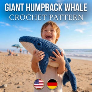 May include: A crochet pattern for a giant humpback whale, featuring text that reads GIANT HUMPBACK WHALE CROCHET PATTERN. The whale is a plush, textured toy with a dark blue top, a cream-coloured underside, and a prominent dark blue eye.