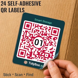 May include: A square self-adhesive QR label with a dark teal background, a magenta and white QR code, and the number 01 in a white circle. The label features the text Smart Storage and TidyBox.eu. The text 24 SELF-ADHESIVE QR LABELS and Stick Scan Find is visible.