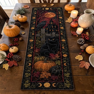 May include: A rectangular table runner featuring a dark, atmospheric Halloween illustration of a black cat, a raven, a haunted house, and pumpkins, framed by a border of moon phases and autumn leaves in shades of orange, red, and black.