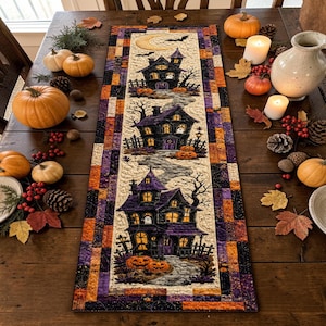 May include: A rectangular quilted table runner featuring a Halloween theme with three dark, multi-story houses, a crescent moon, and bats. The border consists of a patchwork pattern in shades of orange, purple, and black, with a stone path design.