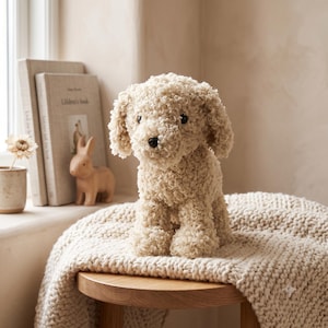 May include: A plush dog toy with curly, cream-colored fabric, dark eyes, and a black nose. The stuffed animal is seated in an upright position, featuring floppy ears and a soft, textured exterior that mimics the appearance of curly fur.