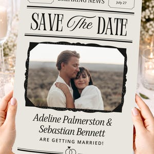 May include: A cream-colored Save the Date card designed like a newspaper with the text BREAKING NEWS, Monday, July 27, and SAVE THE DATE. It features a central photograph of a couple embracing, with the names Adeline Palmerston & Sebastian Bennett.