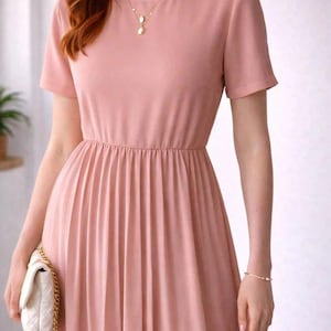 May include: A dusty rose-colored midi dress featuring short sleeves, a round neckline, and a pleated skirt. The dress has a cinched waistline and is paired with a small, white quilted handbag that features a gold-toned chain shoulder strap.