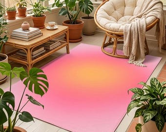 May include: A rectangular area rug featuring a vibrant gradient design that transitions from a bright orange center to a soft pink border. The rug is positioned on a white floor in a sunroom filled with various green potted plants and furniture.