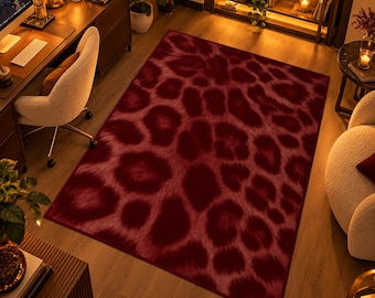May include: A rectangular area rug featuring a deep burgundy and dark red leopard print pattern. The design consists of large, irregular, soft-edged spots in a darker shade against a slightly lighter red background, covering the entire surface.