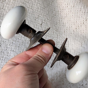 Pair of Antique Round White Porcelain & Cast Iron Door Knobs on Spindle with Set Screws and Rosettes - #1