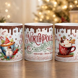 May include: Three white ceramic mugs featuring a brown chocolate drip pattern at the rim. The centre mug displays the text North Pole Hot Chocolate Co. with a Santa graphic. The side mugs feature illustrations of snowman and red mugs with cocoa.