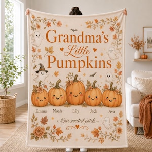May include: A cream-coloured fleece blanket featuring the text Grandma's Little Pumpkins and Our sweetest patch. The design includes five smiling orange pumpkins, several small white ghosts, autumn leaves, and the names Emma, Noah, Lily, Jack, and Ava.