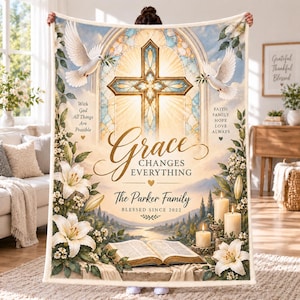 May include: A rectangular fleece blanket featuring a stained glass cross, two white doves, and white lilies. Text reads: With God All Things Are Possible, Grace Changes Everything, Faith Family Hope Love Always, The Parker Family, Blessed Since 2022.