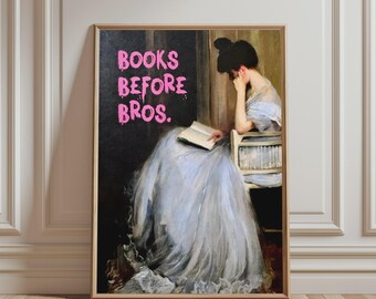 May include: A framed wall art print featuring a painting of a person in a light blue gown sitting on a chair and reading a book. The text BOOKS BEFORE BROS. is printed in bright pink, dripping-style letters on the dark background.