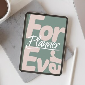 May include: A digital tablet displaying a sage green background with large, light pink text that reads "For Planner Ever" and "Planner" in white script. The tablet is positioned on a gray rectangular surface next to a white stylus.