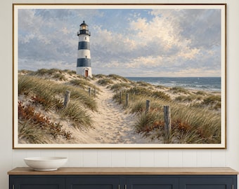 May include: A framed landscape painting depicting a tall lighthouse with horizontal black and white stripes standing on a sandy dune. A narrow path winds through tall beach grass and wooden posts toward the ocean under a cloudy sky.