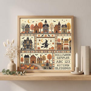 Könnte beinhalten: Ein quadratisches Kreuzstich-Muster in einem Holzrahmen mit Halloween-Motiven wie Häusern, einer Hexe auf einem Besen, Kürbissen, Fledermäusen und Katzen. Der Text lautet HALLOWEEN SAMPLER ABC 123 AUTUMN BLESSINGS in einem Raster mit herbstlichen Farben.