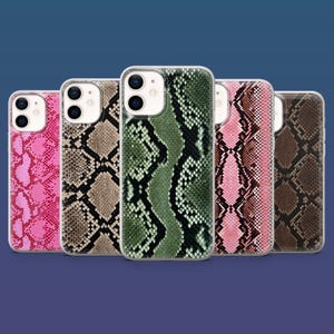 Könnte beinhalten: Fünf Smartphone-Hüllen mit verschiedenen Schlangenhautmustern in Pink, Beige, Grün, Pink-Braun und Dunkelbraun. Jede Hülle hat einen transparenten Rand, einen Ausschnitt für die Doppelkamera und ein strukturiertes Reptilienschuppen-Design.