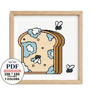 May include: A cross-stitch pattern featuring a slice of bread with light blue mold patches and three small black flies. The design includes a circular badge with the text PDF, DIGITAL PATTERN, 130 * 130 STITCHES, and 7 COLORS.
