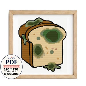 May include: A cross stitch pattern featuring a slice of bread with green mold spots, framed in light wood. A circular badge indicates it is a PDF digital pattern with 120 by 130 stitches and 13 colors. The design uses brown, cream, and green.