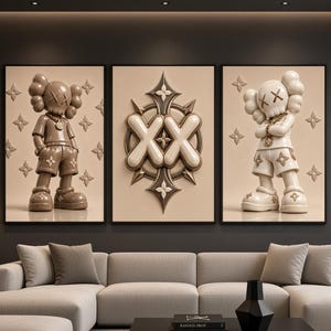 May include: A triptych of three framed wall art prints featuring two cartoon-style figures with X-shaped eyes and a central emblem with the letters XX. The figures are rendered in brown and cream tones with star-shaped accents on a beige background.