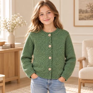 May include: A sage green knit cardigan featuring a ribbed crew neckline, long sleeves, and a front button closure with four light-colored wooden buttons. The garment has a ribbed hem and cuffs, constructed from a textured yarn in a solid green hue.