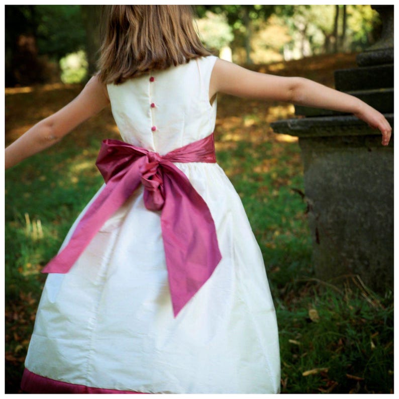 Flower girl dress pdf sewing pattern, cummerbund sash, big bow, classic flower girl frock, pink sash, cream bodice, covered buttons, rouleaux loop fastening. Free You Tube Video playlist. Back view of the handcovered cover buttons.