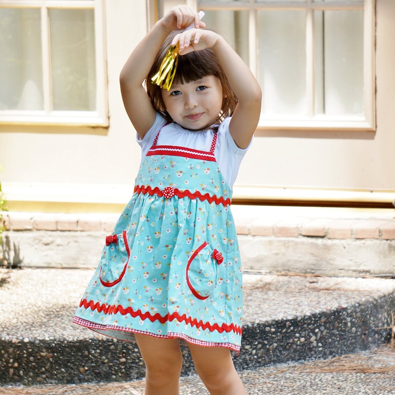Natalie girls pinafore dress, pdf sewing pattern by Frocks & Frolics. High waist and sash with ties.  Here featuring a combination of Michael Miller fabrics in mushroom print and cute patch pockets. Double layer hem completes the look.
